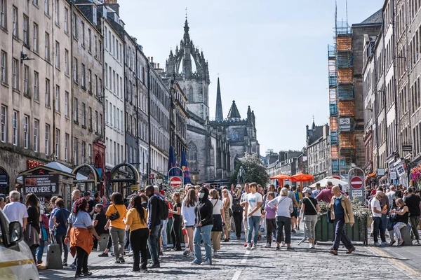 Edinburg, İngiltere - 23 Ağustos 2022: Royal Mile sokak manzaralı turistler. Edinburg 'un kalbinden geçip Edinburgh Kalesi' ni Queen 'in sarayına bağlayan