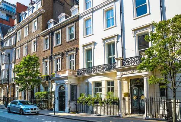 stock image London, UK - 9 September, 2023: Beautiful periodic buildings at Mayfair and luxury cars parked at road. Mayfair one of the richest areas to live with fancy lifestyle