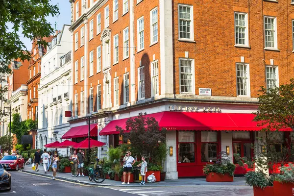 stock image London, UK - 9 September, 2023: Mayfair street cafe and people relaxing and eating out. Mayfair  one of the richest areas to live with fancy lifestyle