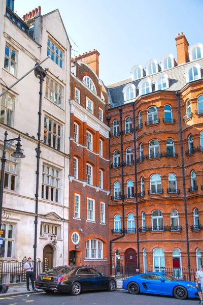 stock image London, UK - 9 September, 2023: Beautiful periodic buildings at Mayfair and luxury cars parked at road. Mayfair one of the richest areas to live with fancy lifestyle