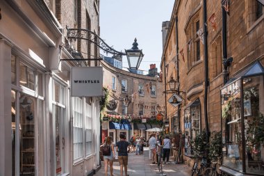 Cambridge, UK - July 16, 2023: Cambridge High street view with cafes, ships, restaurants and walking people clipart