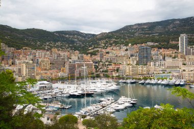Monaco, Monte Carlo - 15 Eylül 2023: Monako Prensliğinde Günbatımı. Limanın ve Monte Carlo şehrinin lüks yatları ve yelkenli tekneleri var.