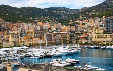Monaco, Monte Carlo - 15 Eylül 2023: Monako Prensliğinde Günbatımı. Limanın ve Monte Carlo şehrinin lüks yatları ve yelkenli tekneleri var.