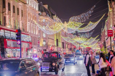 Londra, İngiltere - 8 Kasım 2024: Noel Ruhu, Regent sokağı Noel ışıkları, Londra 2025 için aydınlatıldı. Kalabalık cadde, insanlar ışıkların tadını çıkarıyor, yürüyor, alışveriş yapıyor. 