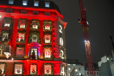 Londra, İngiltere - 8 Kasım 2024: Bond Caddesi 'nde Noel ışıkları. Londra Noel ve 2025 yılbaşı kutlamaları için aydınlatıldı. Kalabalık cadde, insanlar ışıkların tadını çıkarıyor ve alışveriş yapıyorlar. 