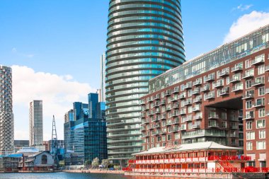 Londra, İngiltere - 14 Haziran 2025: Millwall iç iskelesi Canary Wharf 'ın yanında, gün batımında yerleşim yeri gökdelenleri manzaralı 