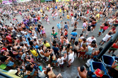 salvador, bahia, brazil - february 22, 2023: revelers are seen next to a trio eletrico during the canaval in the city of Salvador. clipart