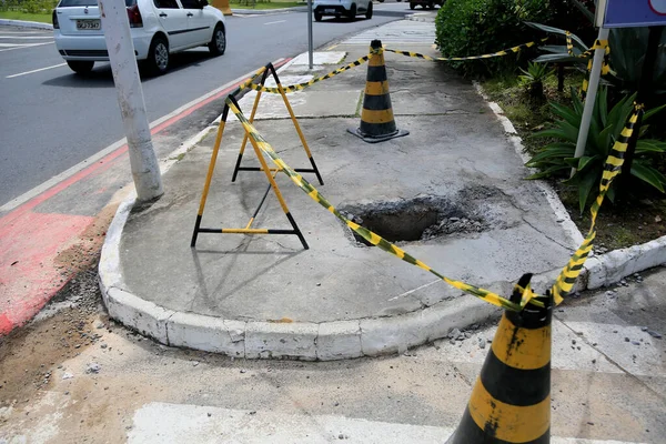 Salvador, Bahia, Brezilya - 16 Mayıs 2023: Koni ve güvenlik bandı Salvador şehrinin kaldırımında delik olan yerel işaret