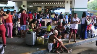 Salvador, Bahia, Brezilya - 22 Haziran 2023: Sao Joao dönemindeki Salvador otobüs durağındaki otobüslere binmeye çalışan kalabalık.