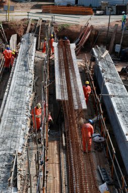 salvador, bahia, brazil - june 26, 2023: Workers on the construction of a concrete bridge in the city of Salvador.
