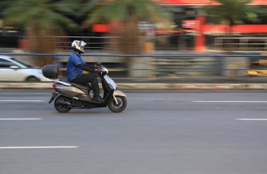 Salvador, Bahia, Brezilya - 11 Ağustos 2023: motosiklet sürücüsü Salvador şehrinde bir bulvardan geçerken görüldü..