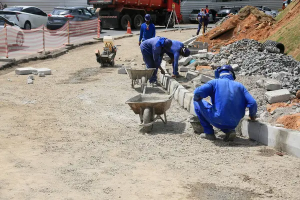 stock image salvador, bahia, brazil - september 25, 2023: workers building curbs on a street in the city of Salvador