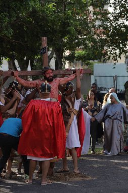 salvador, bahia, brazil - march 29, 2024: actors perform the passion of christ in the city of salvador. clipart