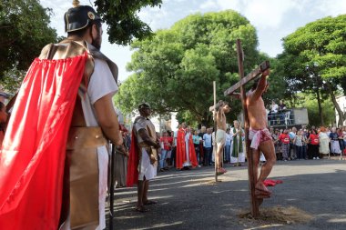 salvador, bahia, brazil - march 29, 2024: actors perform the passion of christ in the city of salvador. clipart