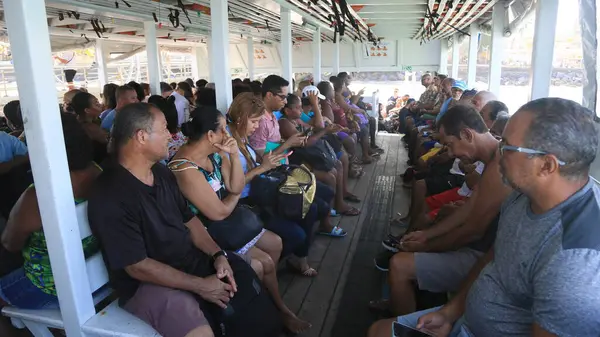 stock image vera cruz, bahia, brazil - october 13, 2023: passengers using a boat to cross from Mar Grande to Salvador through the waters of Baia de Todos os Santos.