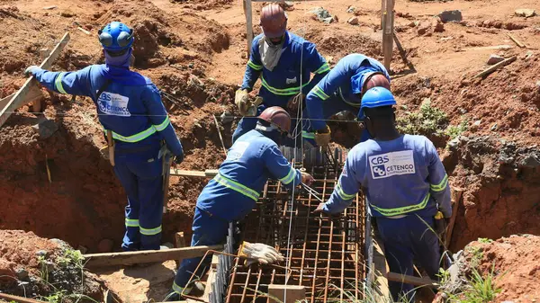 stock image salvador, bahia, brazil - april 29, 2024: workers building a public road in the city of Salvador.