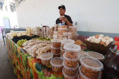 boninal, bahia, brazil - october 2, 2024: view of a stall at a street market selling family farm produce. clipart