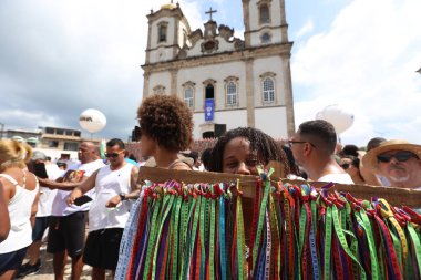 salvador, bahia, brazil - january 2025: Devotees of Senhor do Bonfim participate in the washing of the church steps. clipart