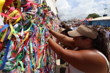 salvador, bahia, brazil - january 2025: Devotees of Senhor do Bonfim participate in the washing of the church steps. clipart