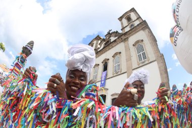 salvador, bahia, brazil - january 2025: Devotees of Senhor do Bonfim participate in the washing of the church steps. clipart