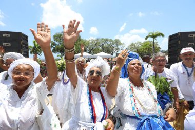 salvador, bahia, brazil - january 2025: Devotees of Senhor do Bonfim participate in the washing of the church steps. clipart