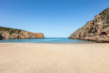İki tepenin arasındaki vadide güzel sahil ve berrak su, Cala Domestica plajı, sardunya, İtalya