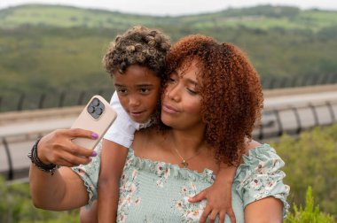 Woman and her son seen takinng a selfie