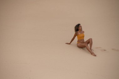 Pretty woman seen sitting at the beach