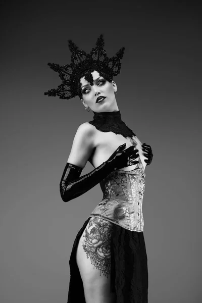 stock image Portrait of a young woman wearing a lace cap, a corset and black latex gloves