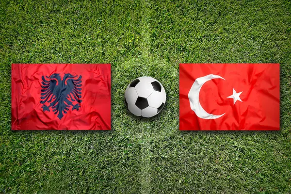 stock image Albania vs. Turkey flags on green soccer field