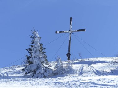 Summit cross of Setzberg mountain, Bavaria, Germany,  in wintertime clipart