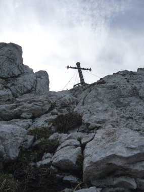 Summit cross of Kampenwand mountain tour in Bavaria, Germany in springtime clipart