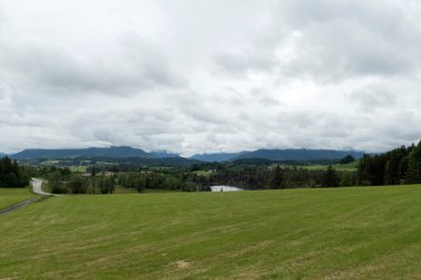 Hiking trail from Steingaden to Bernbeuren, Munich Way of St. James, Bavaria, Germany in summertime clipart