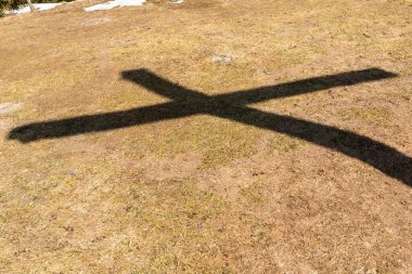 Shadow summit  cross of Rechelberg mountain, Bavaria, Germany,  in springtime clipart