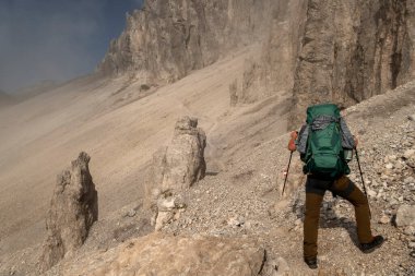 Mountaineer at Eppzirler Scharte, Karwendel mountains, Solsteinhaus hut on Karwendel Hohenweg, Austria in autumn clipart