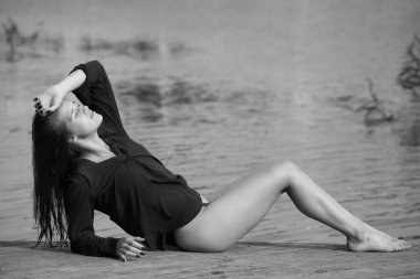 slim young woman in red shirt and bikini
