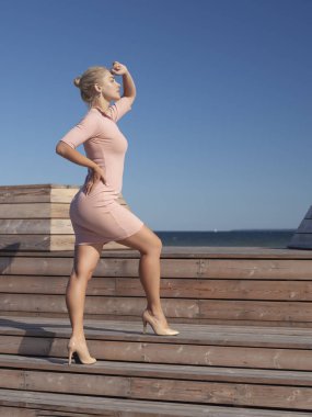 Dar elbiseli narin sarışın kadının portresi.