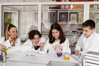 Education. Chemical experiments at a chemistry lesson at school. Children classmates making experiments in the laboratory