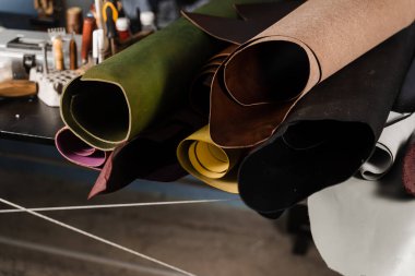 Handmade genuine leather production in the factory. Rolls of genuine leather of different colors in leather products workshop