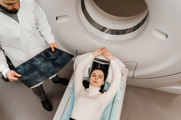 Girl patient is doing CT computed tomography x-ray scan of chest for examination of abdomen in a CT scanning room. CT scan of abdomen of woman in medical clinic