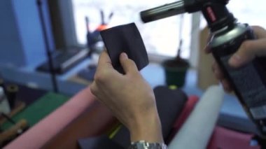 4k video process of fire burning genuine leather with burner to create leather products. Craftsman is burning and creating genuine leather product