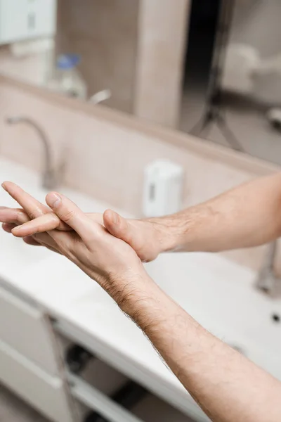 Doctor surgeon is washing hands before surgery in medical clinic. Hygiene. Correct hand washing with soap, gel and water