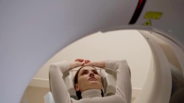 4k video girl patient is doing CT computed tomography x-ray scan of chest for examination of abdomen in a CT scanning room. CT scanning of abdomen of woman in medical clinic