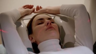 4k video CT x-ray examination of lung cancer in medical clinic close-up. Patient girl lies on computed tomography bed and scanning lungs for diagnose lung cancer in medical clinic