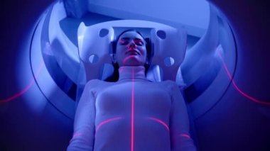 4k video CT x-ray examination of lung cancer with red lines and blue light in medical clinic. Patient girl lies on computed tomography bed and scanning lungs for diagnose lung cancer