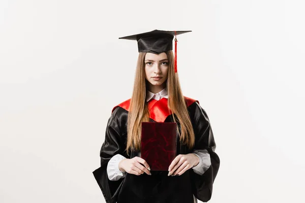 Confident student with diploma in graduation robe and cap ready to finish college. Future leader of science. Academician young woman in black gown smiling