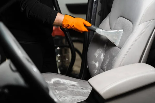 Line on textile car seat after extraction water and detergent of dry cleaning extractor machine. Dry wash cleaner is removing dirt and dust from car seat using dry cleaning extraction machine