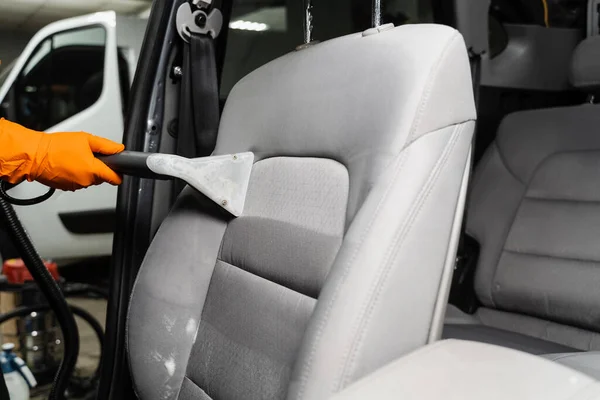 Line on textile car seat after extraction water and detergent of dry cleaning extractor machine. Dry wash cleaner is removing dirt and dust from car seat using dry cleaning extraction machine