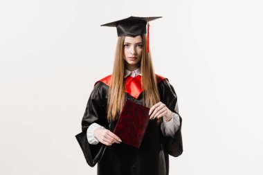 Student with diploma in graduation robe and cap ready to finish college. Future leader of science. Academician young woman in black gown smiling