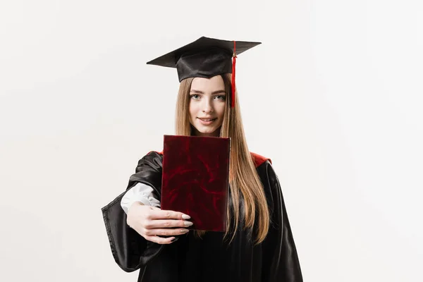 Student with diploma in graduation robe and cap ready to finish college. Future leader of science. Academician young woman in black gown smiling